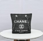 Stylish black canvas and leather tote showcasing the Chanel Replica Deauville Chain Tote Bag C74.
